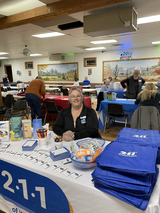 Wyoming 211 's resource database supervisor Jane hosting a Wyoming 211 table booth