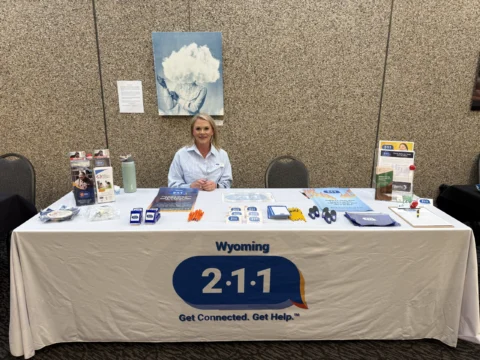 Kinship navigator Chandra pictured sitting behind table at an event
