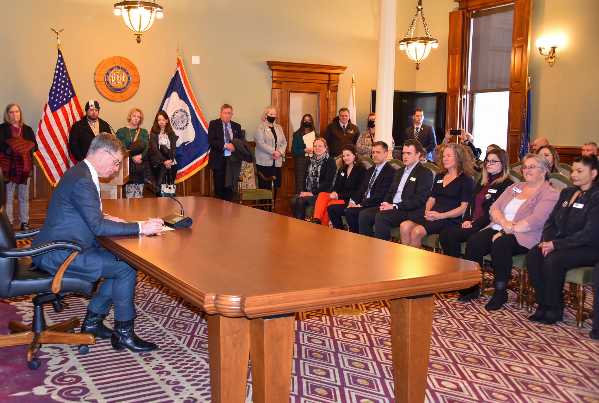 Wyoming 211 staff pictured with current Wyoming Governor Mark Gordon as he signs the 211 day proclamation