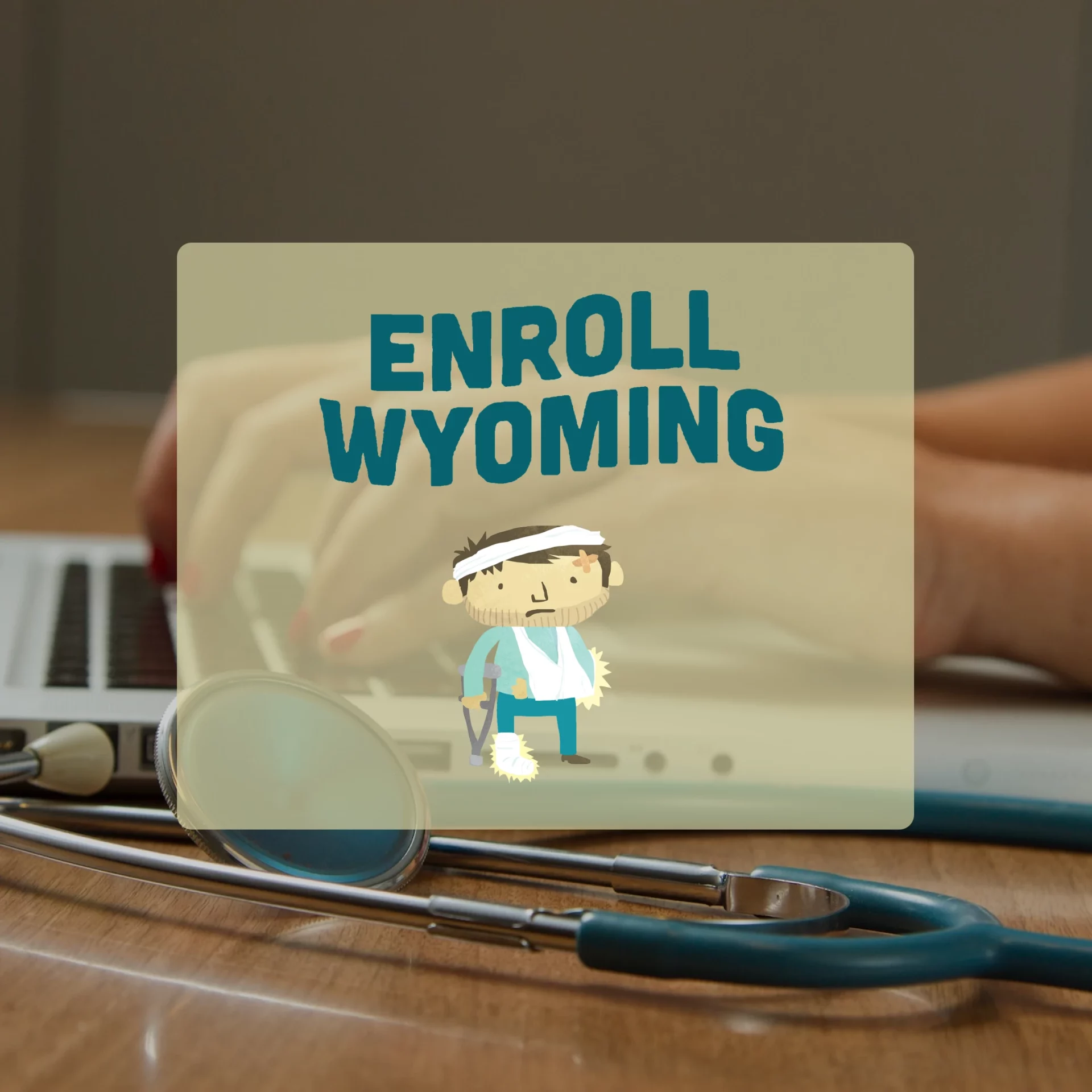 Stethoscope on table next to a laptop with female hands typing on the keyboard. The Enroll Wyoming logo is the center focal point in front of the image