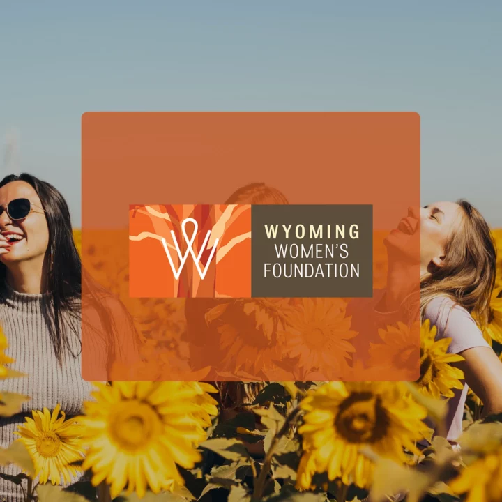 group of girls laughing in the background with the Wyoming women's foundation logo in front