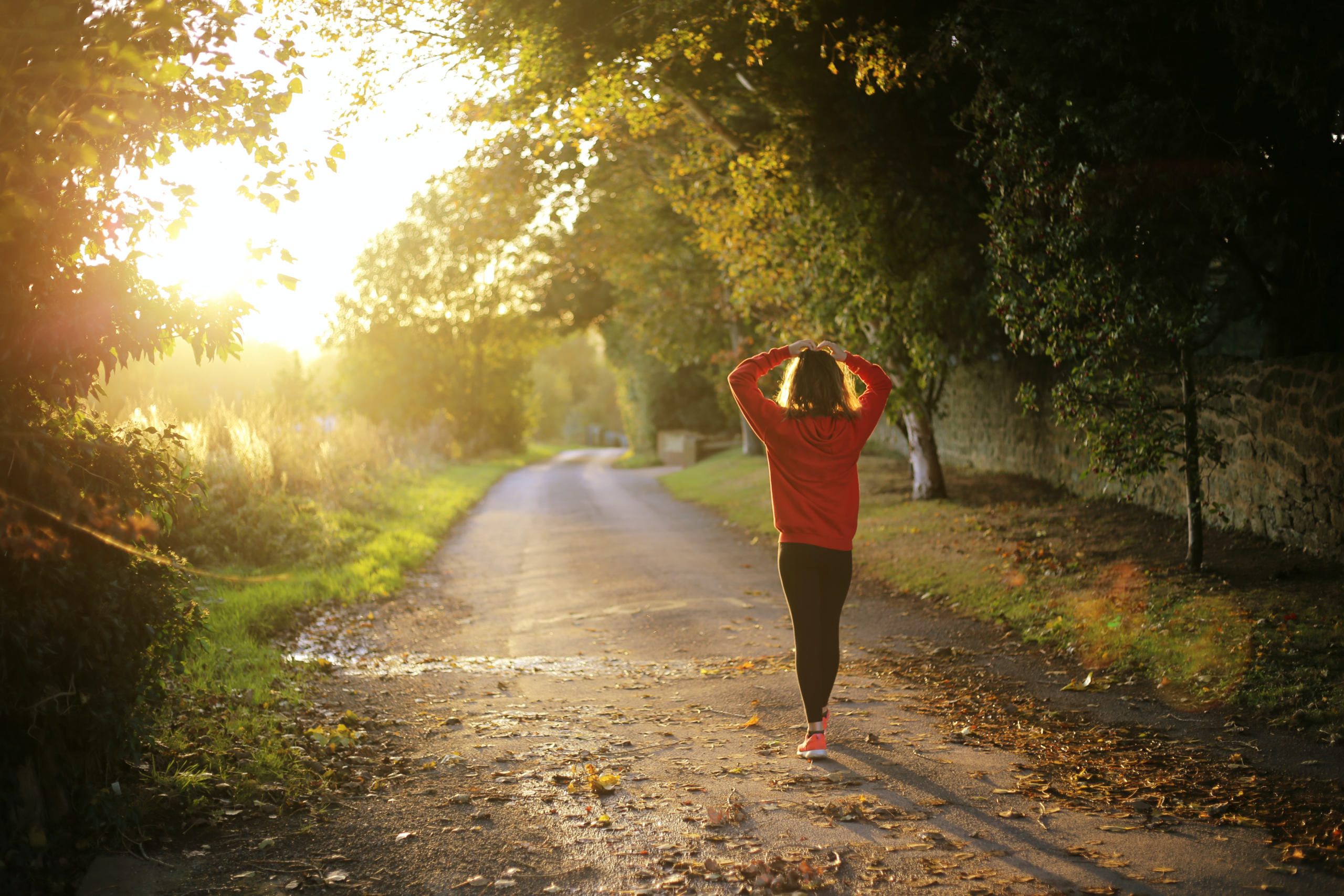 woman walking on a pathway during daytime